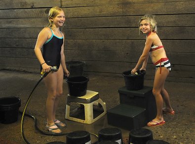 Kristen and her friend clean out feed buckets at Bits & Bytes Farm. July 12, 2008