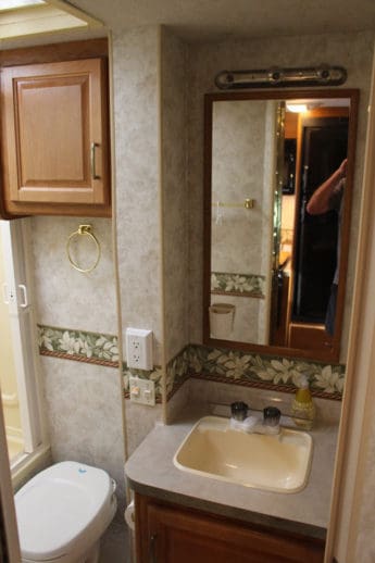 Roomy bathroom with tube/shower, toilet and sink.