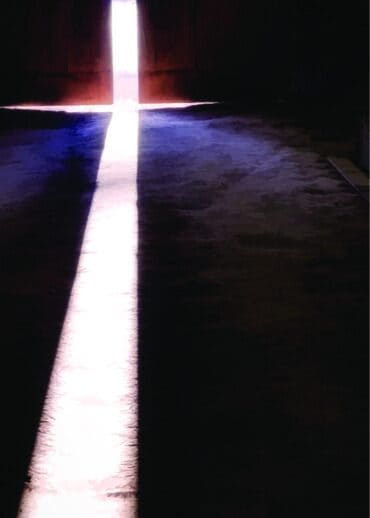 Light shining through the barn doors, at Bits & Byte Farm, on Good Friday form a lighted cross.
