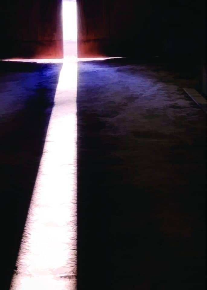 Light shining through the barn doors, at Bits & Byte Farm, on Good Friday form a lighted cross.